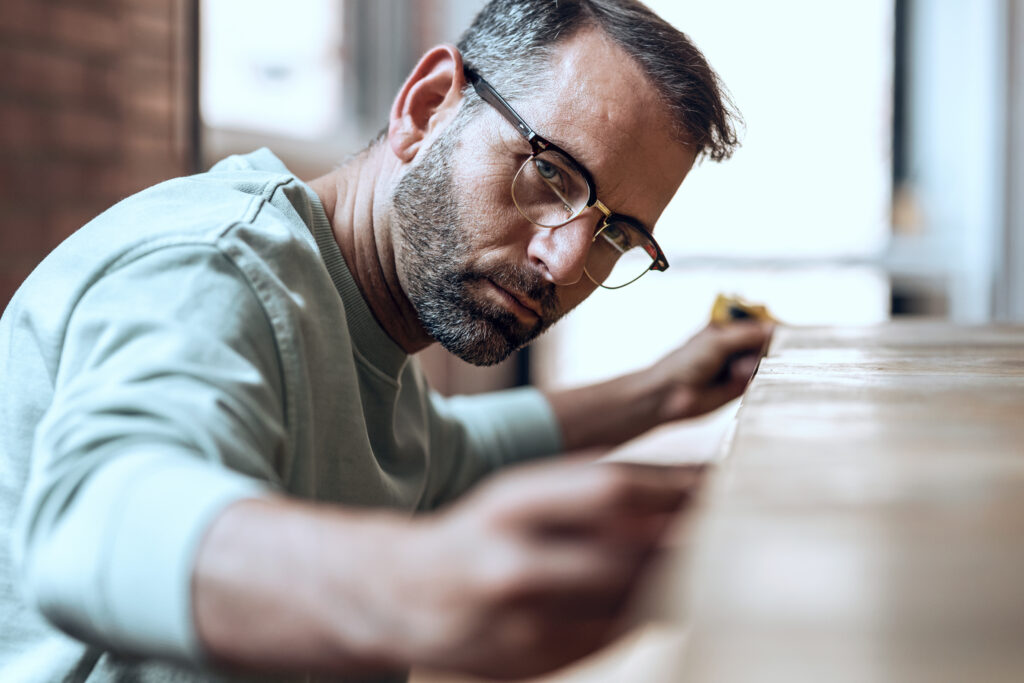 Man with glasses woodworking