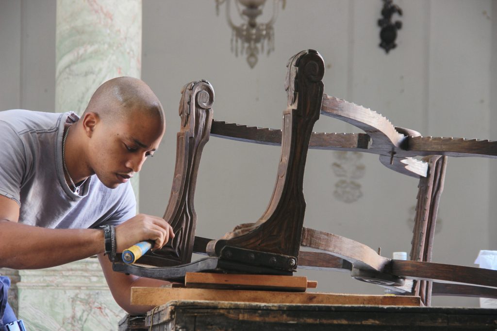 Woodworker restoring the frame of a vintage wooden chair
