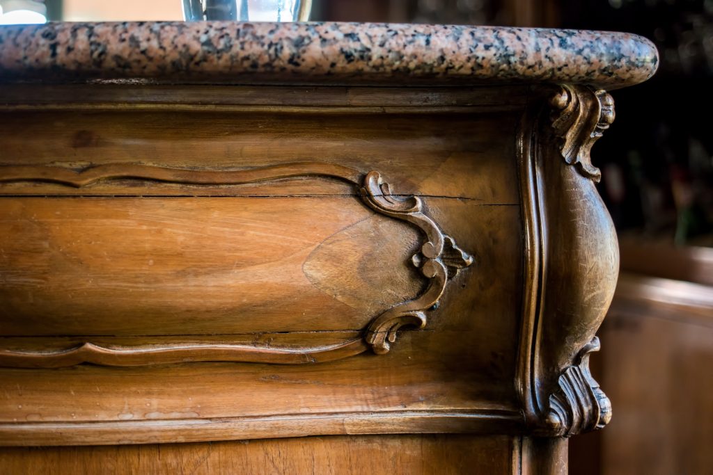older piece of furniture with marble top