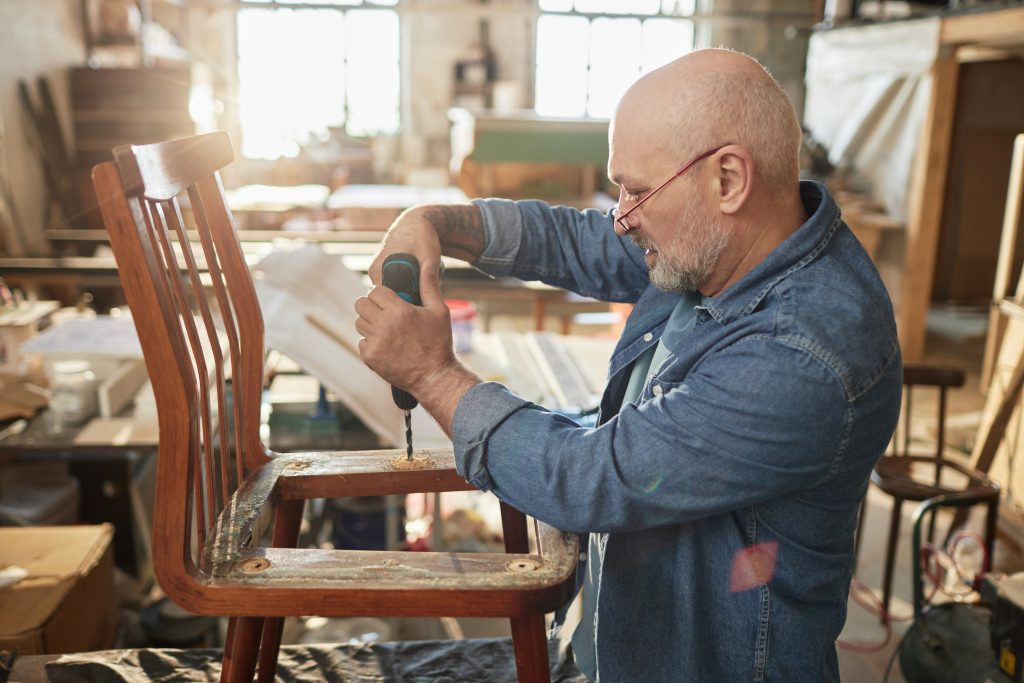 Older man working on furniture