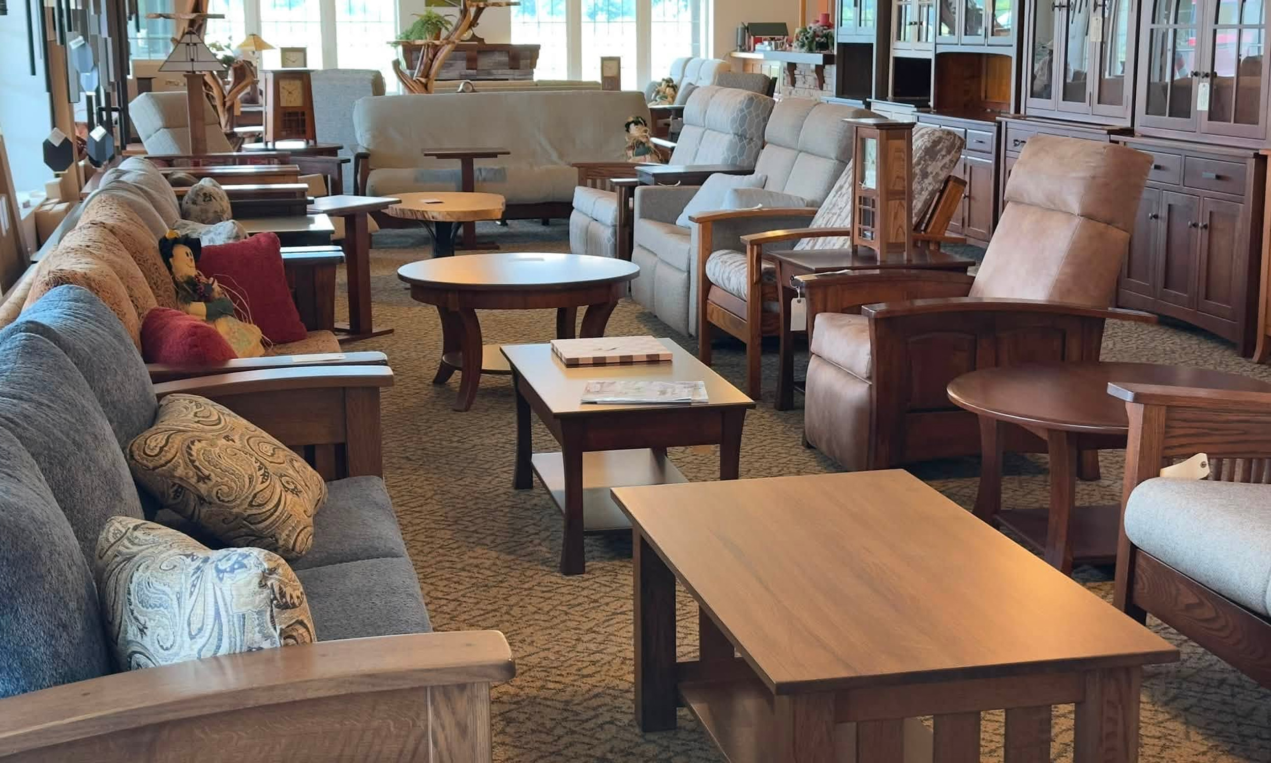 Showroom display of mission-style living room furniture and coffee tables