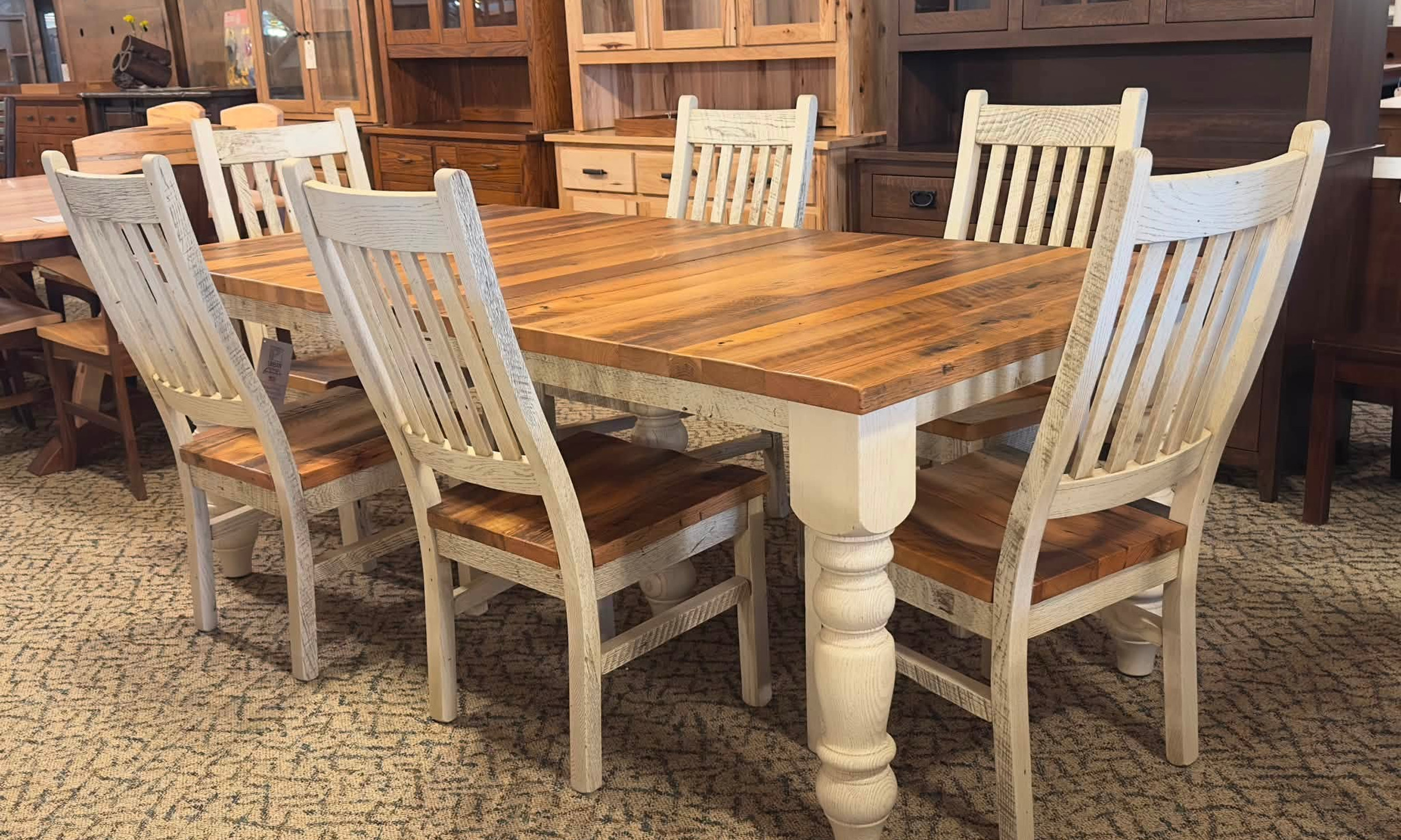 Farmhouse dining table with a wood top, white turned legs and matching chairs
