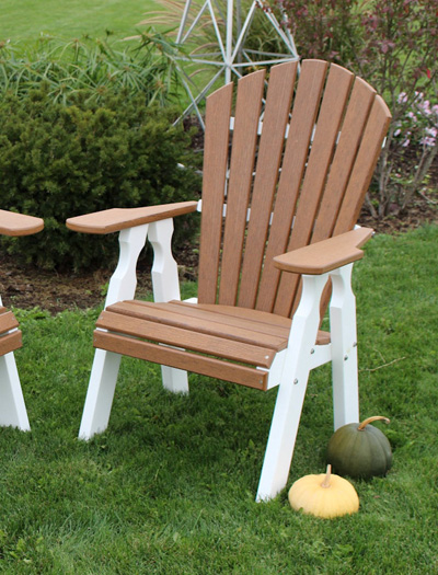 Two-tone poly Adirondack chair on a lawn with autumn pumpkins